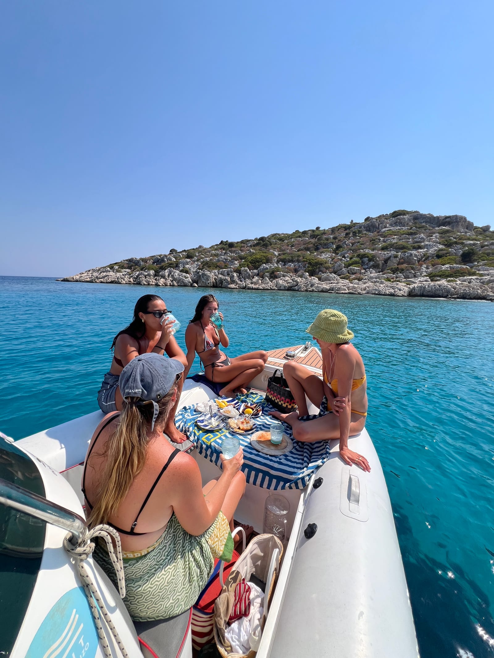 A picnic spread laid on the bow of the boat at anchor